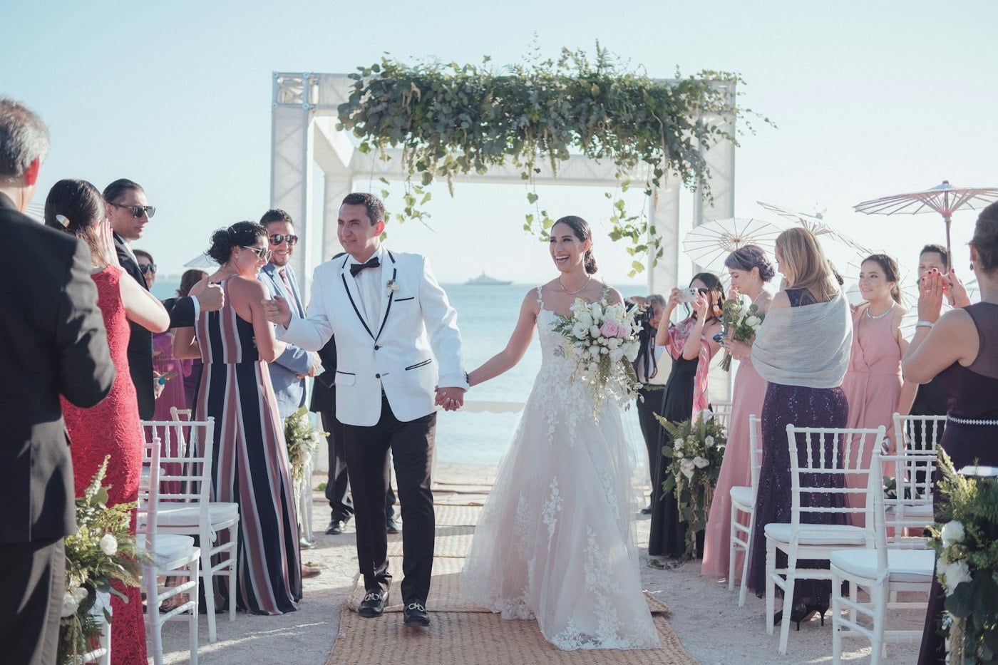 Newlyweds walking back down the aisle after their ceremony